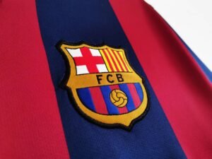 2014/15 Barcelona Home Messi #10 Jersey, worn by Lionel Messi during the 2014/15 season, featuring the iconic FC Barcelona colors and Messi's legendary #10.